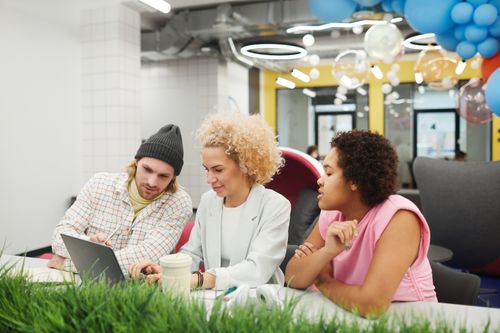 Free Diverse group of young professionals collaborating on a project in a vibrant office space. Stock Photo