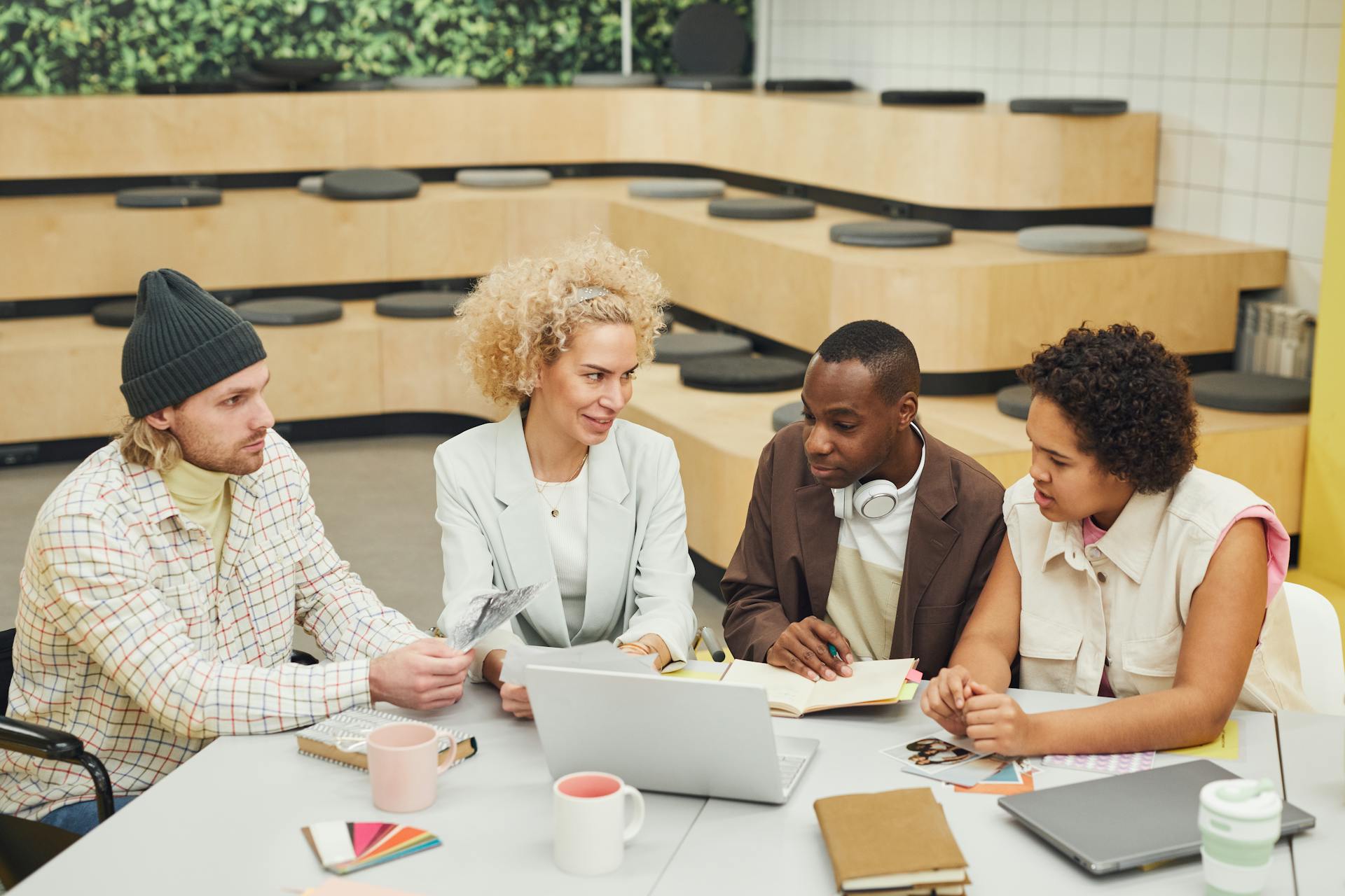 A diverse group of coworkers engaged in a brainstorming session in a modern office setting.