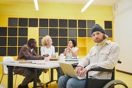 Inclusive office meeting showcasing teamwork and diversity with people collaborating indoors.