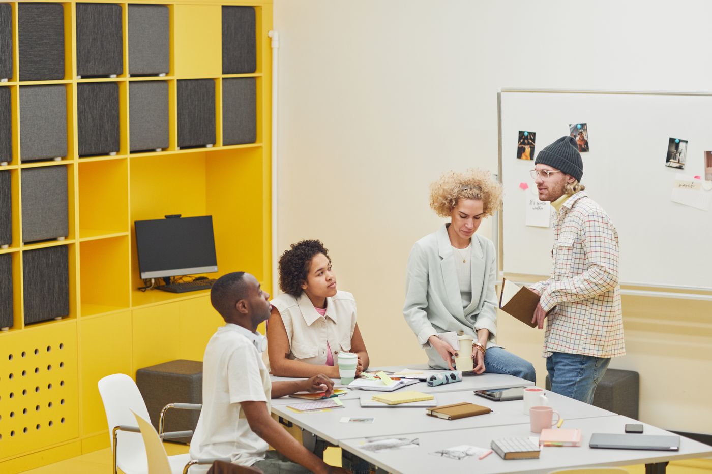 A diverse team in a modern office discussing plans and priorities.
