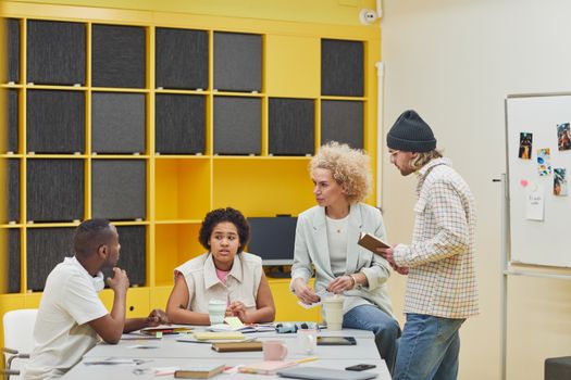A diverse team of professionals collaborating in a modern, cheerful office environment.
