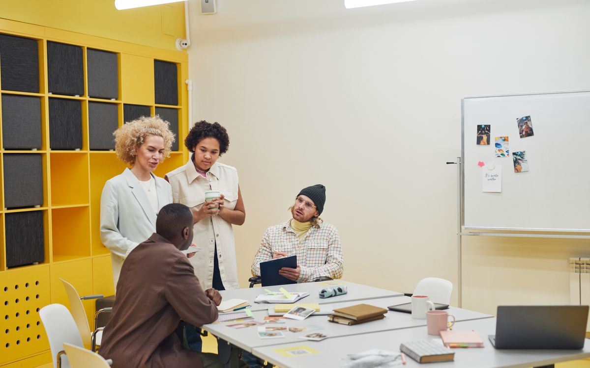 A diverse group of professionals having a collaborative meeting in a modern office space.