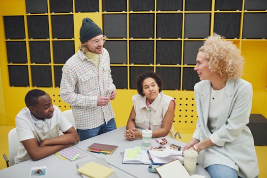 A diverse group of colleagues collaborating at a desk in a modern office setting.