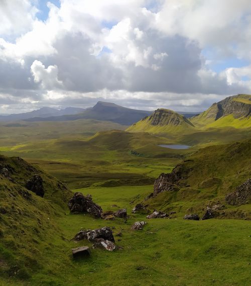 Free Breathtaking view of the Quiraing's lush green hills and dramatic clouds in Scotland. Stock Photo