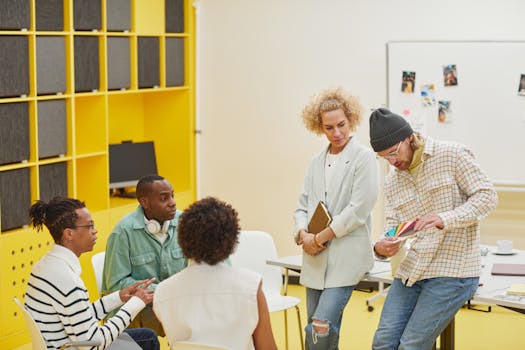 Diverse team discussing projects with color samples in a bright, modern office setting.