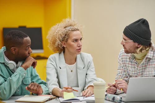 Free A diverse group of professionals discussing ideas during a productive office meeting. Stock Photo