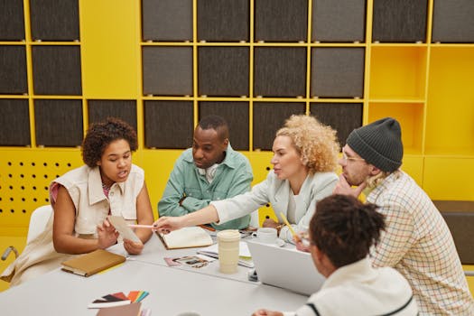 A group of coworkers engaged in a collaborative meeting at a modern office table.