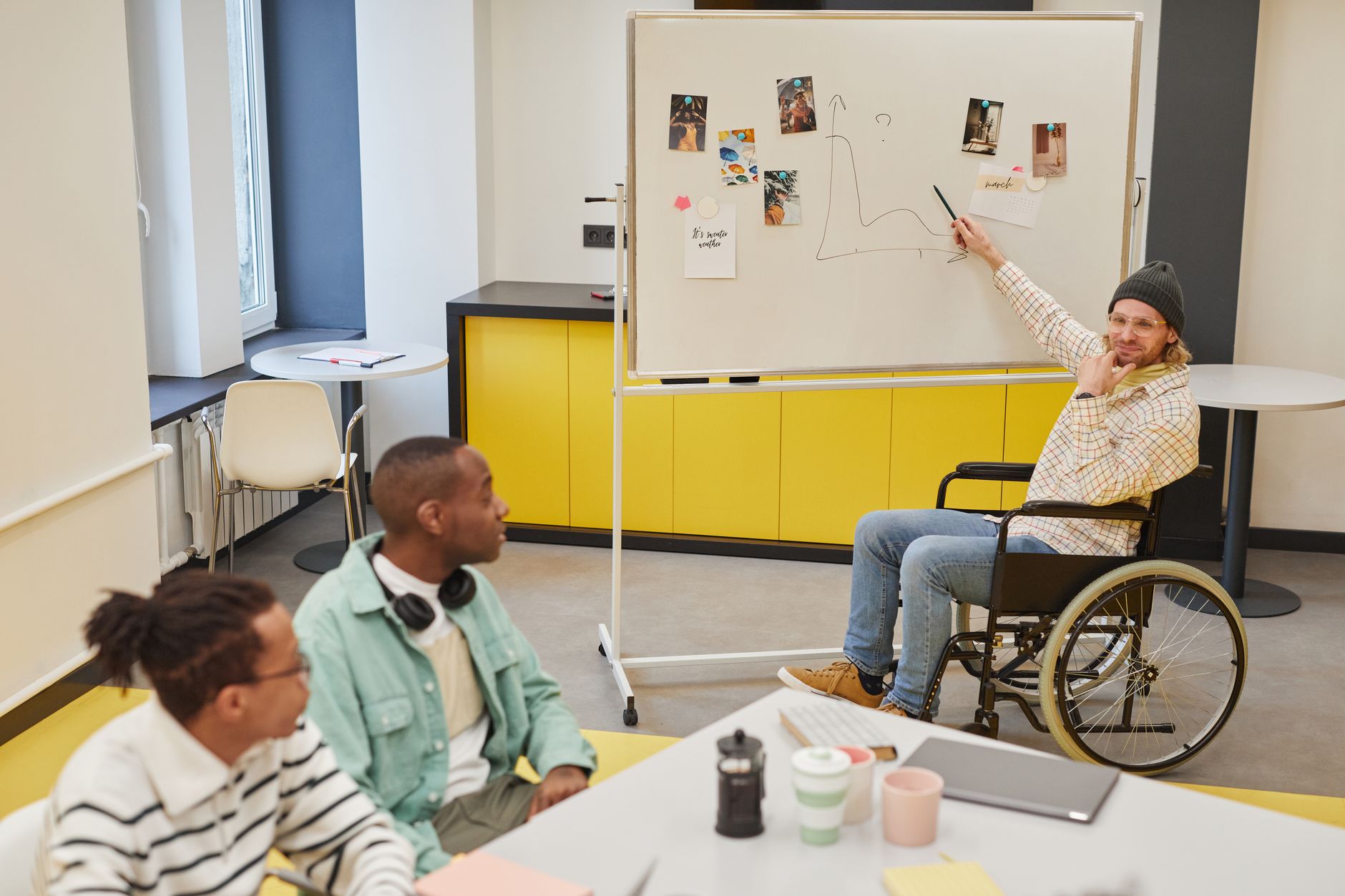 Diverse team discussing ideas during a meeting with a whiteboard presentation.