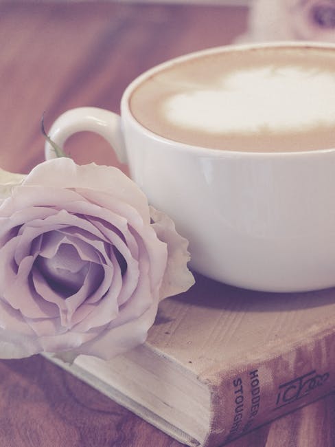 Photography of Flower Beside Coffee on Top of Book