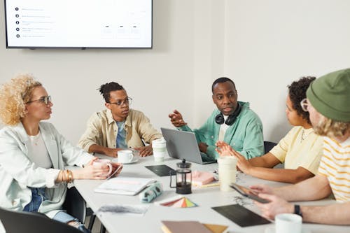 Free People Having a Discussion at the Office Stock Photo