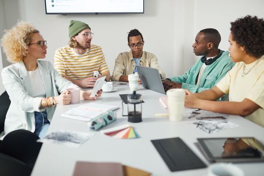 A diverse group of colleagues collaborating in a modern office setting.