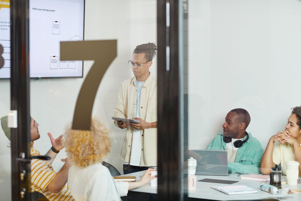 Colleagues collaborating on a planning session in a modern conference room