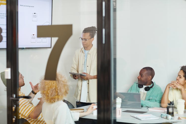 A Team Having A Meeting Inside The Conference Room