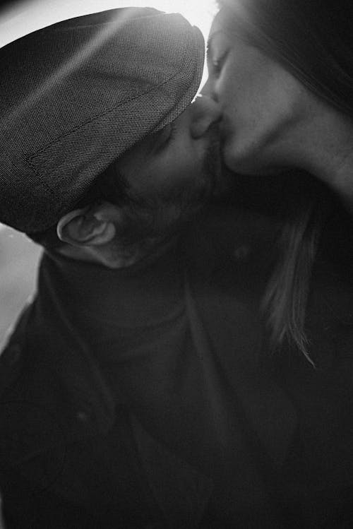Grayscale Photo of Couple Kissing