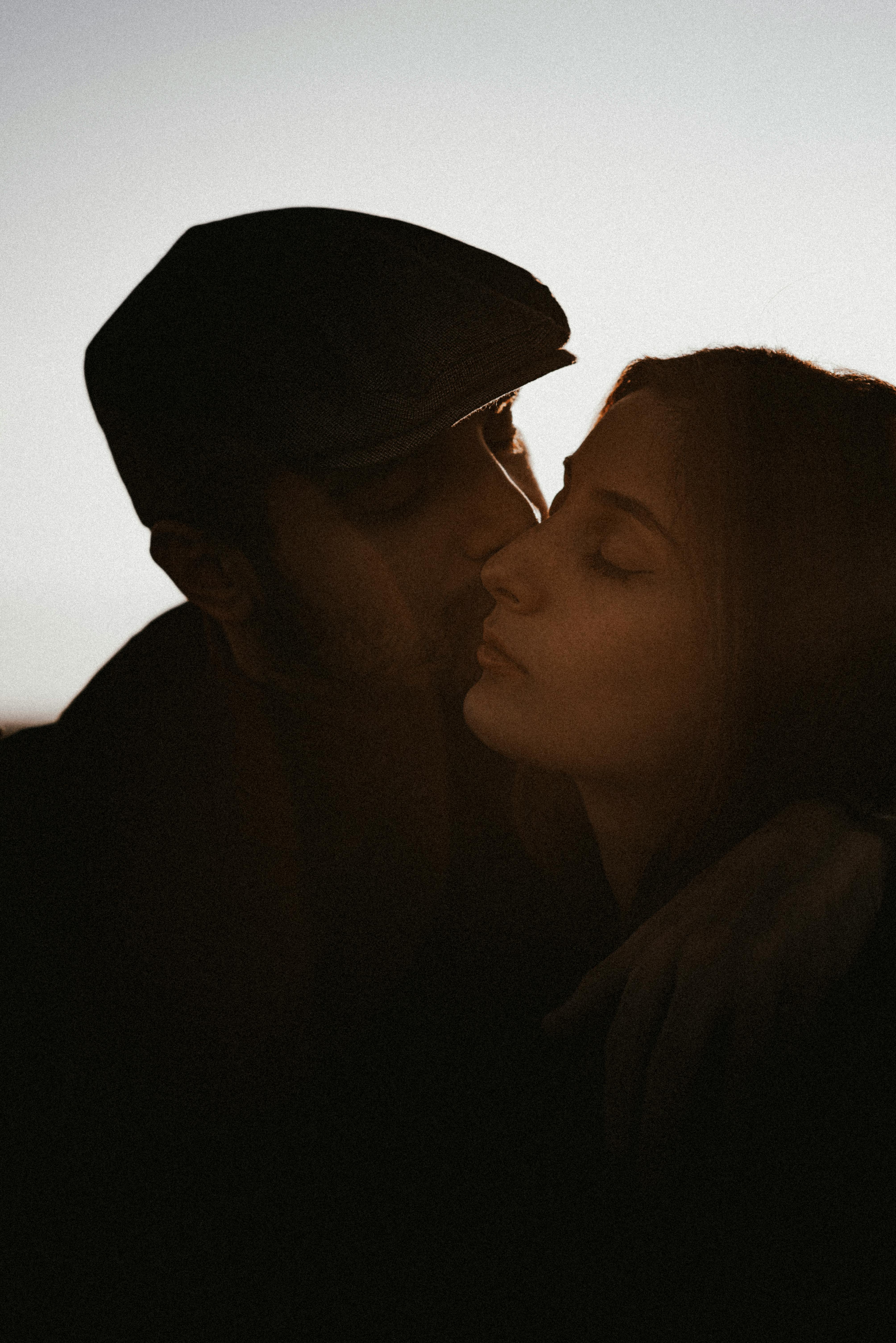 A close-up portrait of a loving couple sharing an intimate moment, captured in a warm, romantic light.