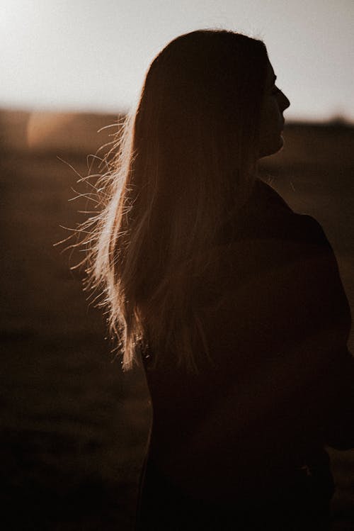 Woman with Long Hair Standing Outside