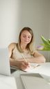 Woman in White Tank Top Writing on White Paper