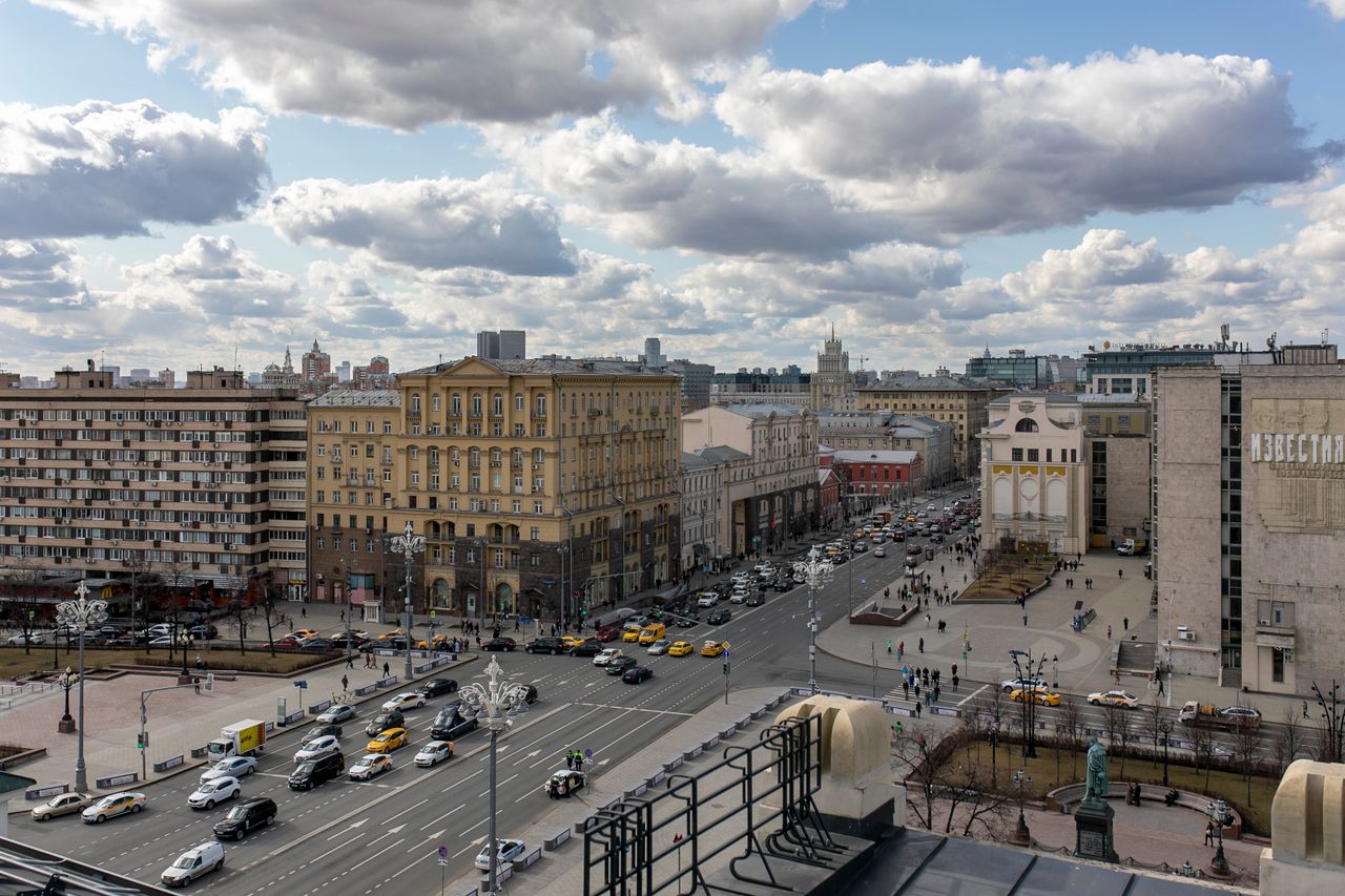 aerial view of bustling moscow city with traffic under a cloudy sky sh