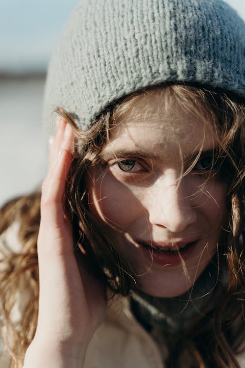 A Close-up Shot of a Woman in Gray Knitted Cap