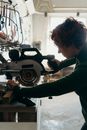 A Woman Using a Miter Saw