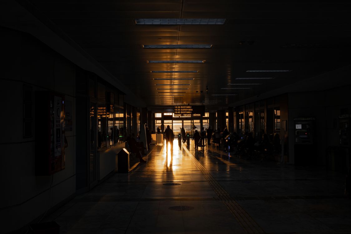 People in Airport Terminal at Dusk · Free Stock Photo