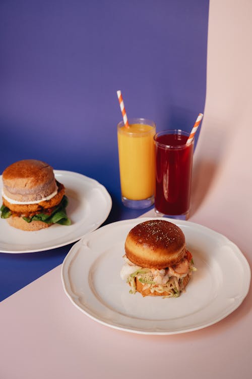Free Two Burger Meals on White Plates Stock Photo