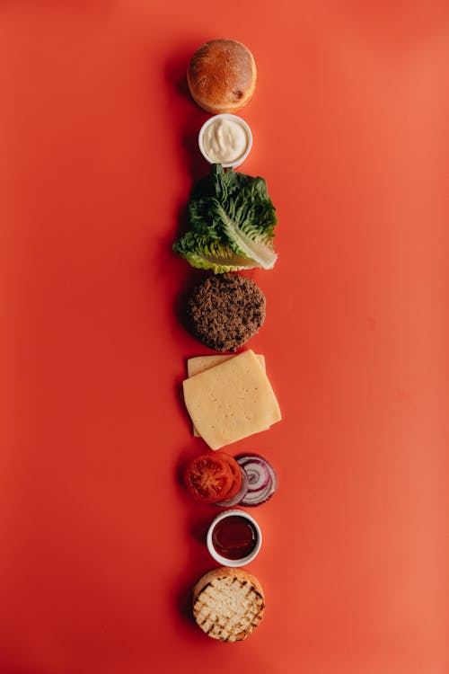 Deconstructed Burger on Red Surface