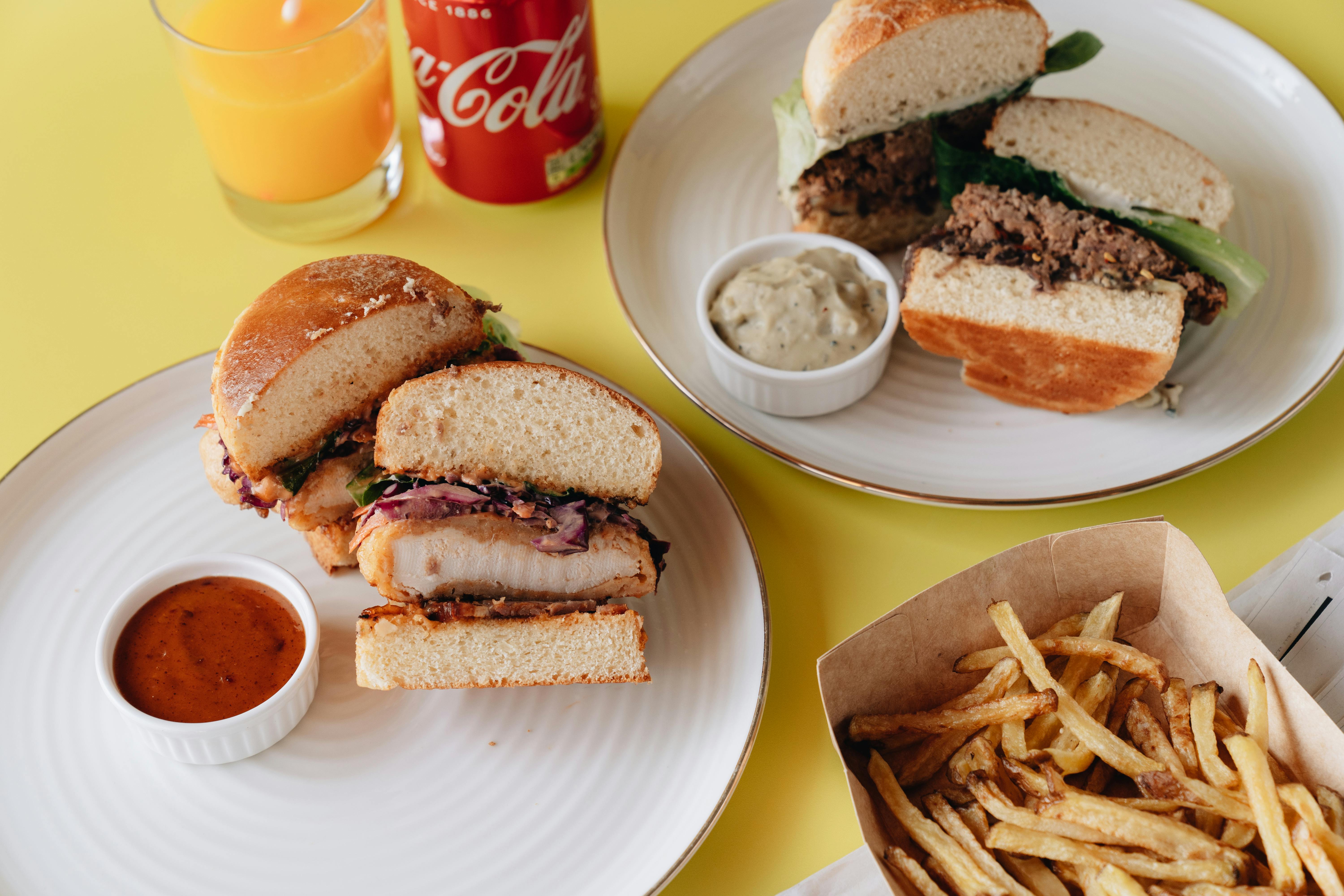 Two Burger Meals on White Plates · Free Stock Photo