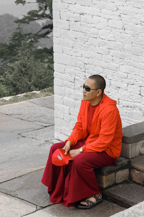 A Man in Orange Jacket Wearing Sunglasses