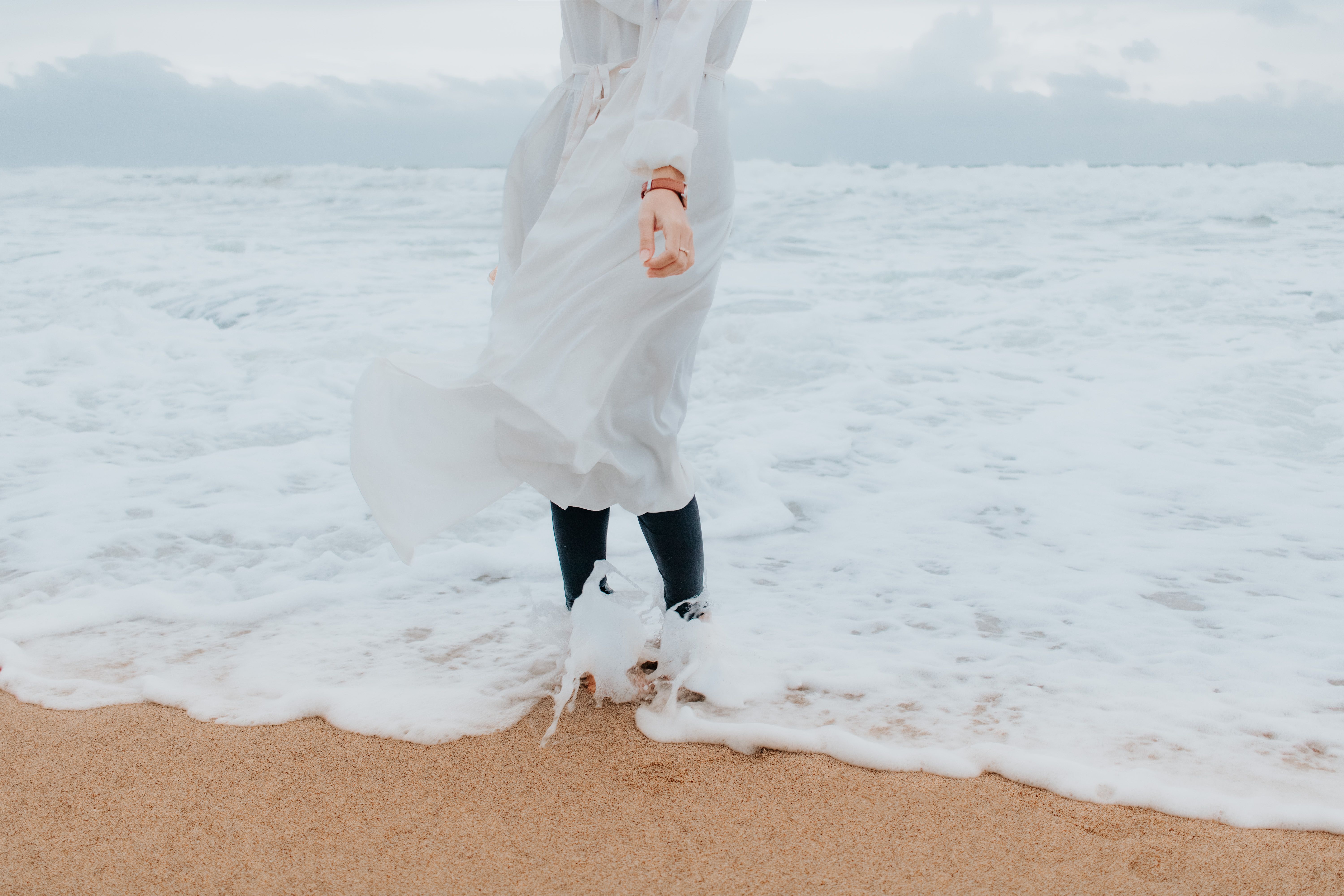 A Woman in White Dress Standing on Beach Shore · Free Stock Photo