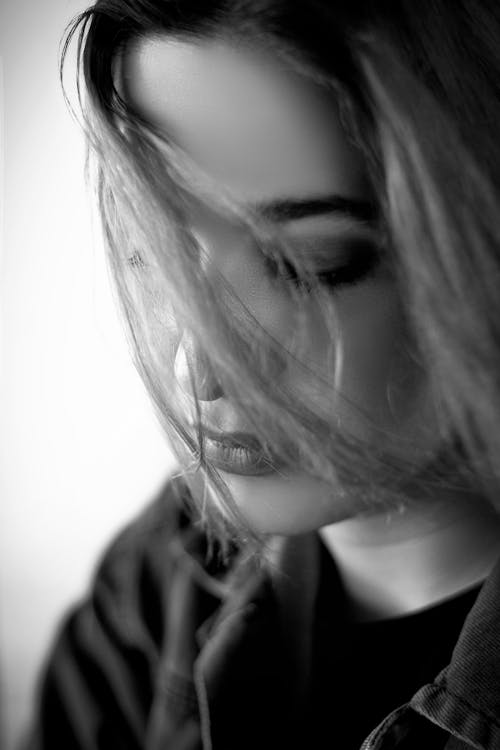 Grayscale Photo of a Woman's Hair Covering Her Face