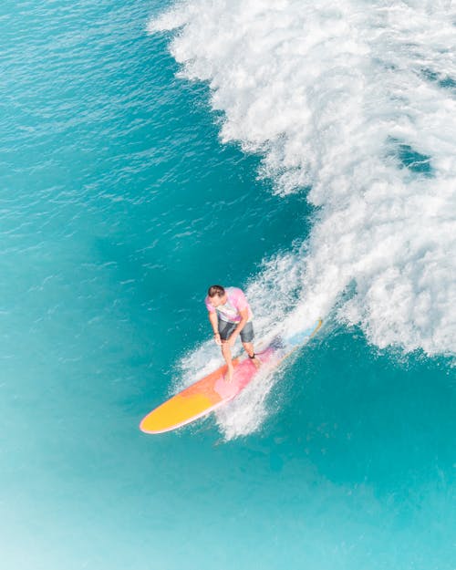 Peron Riding a Surf Board