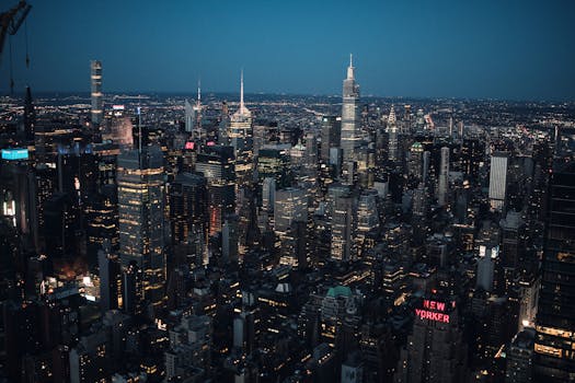 A breathtaking aerial view of New York City's illuminated skyline at night, showcasing iconic skyscrapers.