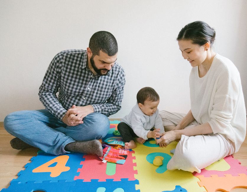 Photo by Meruyert Gonullu on Pexels A joyful family playing together on colorful puzzle mat indoors, fostering happy and diverse family moments. - Photo by Meruyert Gonullu on Pexels