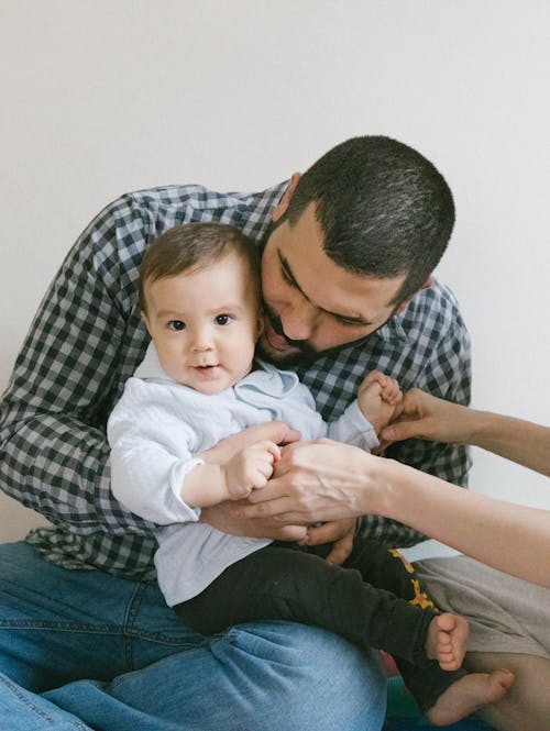 Free Father Holding His Cute Son Stock Photo