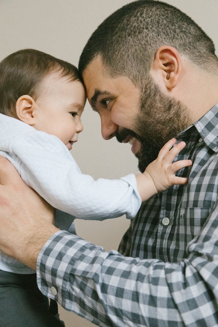 Man Carrying Baby With Sweater