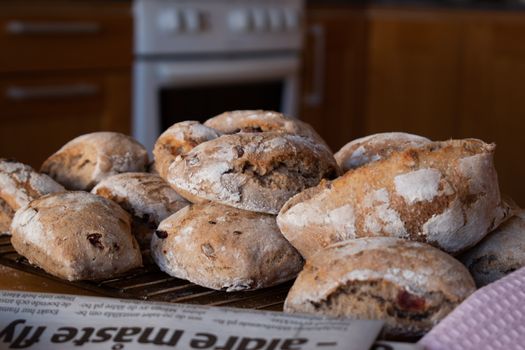 Freshly baked sourdough buns cooling in a kitchen setting, inviting and delicious.