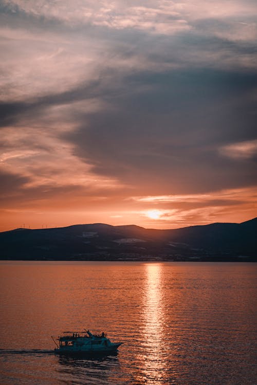 Silhouette of Mountain Near Body of Water during Sunset