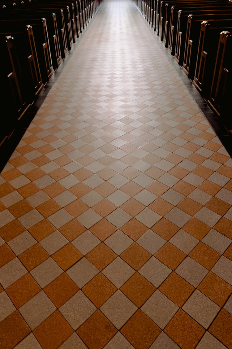 Brown And White Floor Tiles Of A Church's Aisle