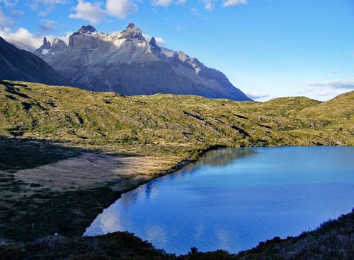 Free Stunning view of the Andes mountains with a clear lake reflecting the blue sky in Patagonia, Chile. Stock Photo