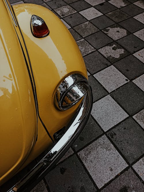 Free Yellow Volkswagen Beetle on Gray Brick Pavement Stock Photo