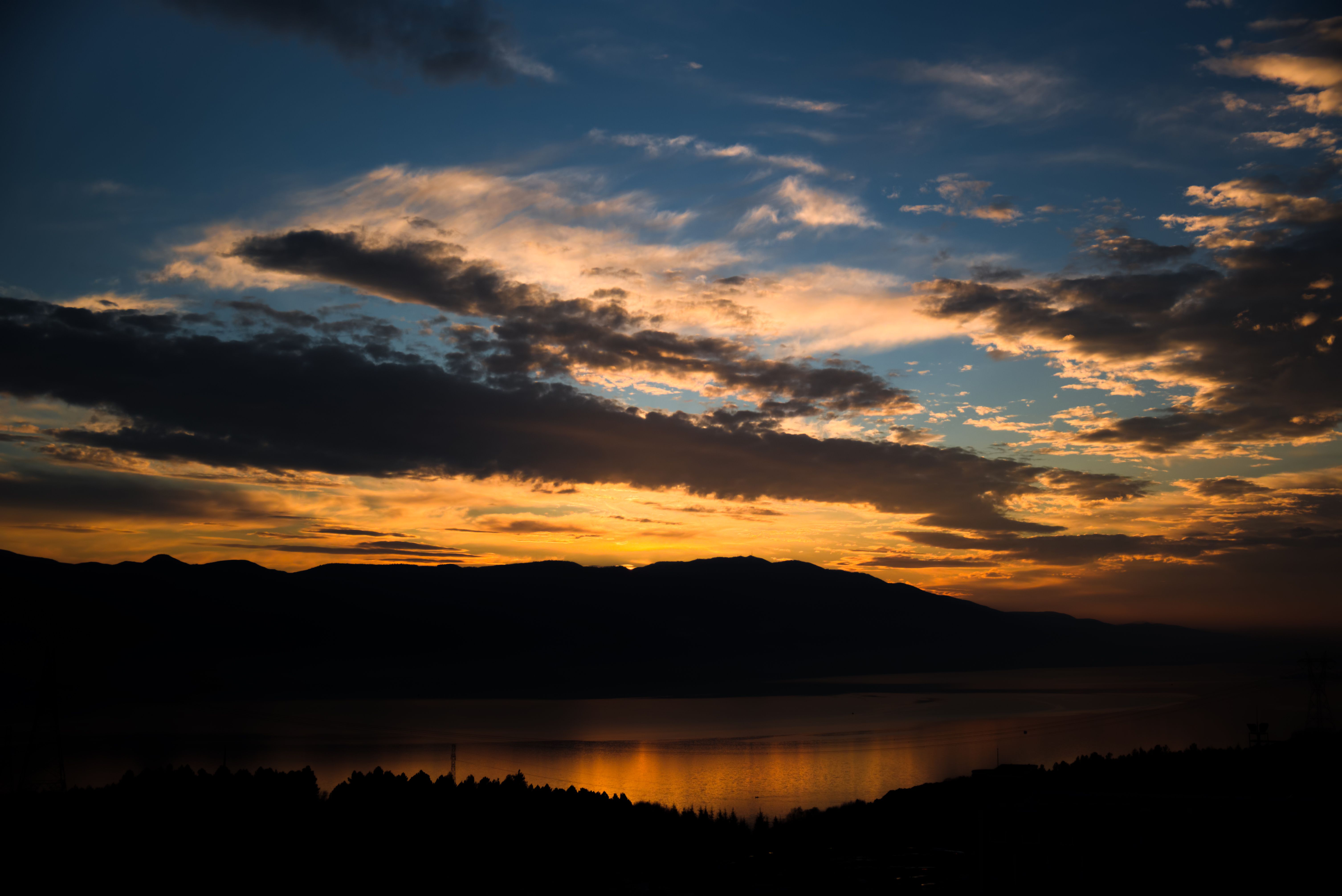 Silhouette of Mountain Near A Lake During Sunset · Free Stock Photo