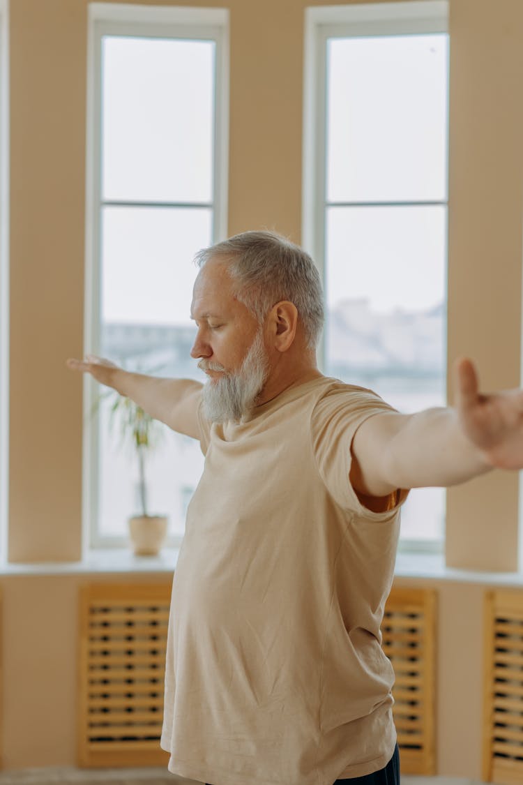 An Elderly Man With His Arms Outstretched