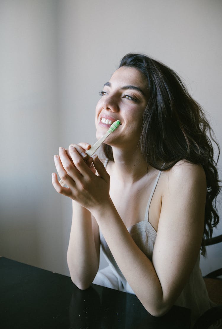 A Happy Woman Holding A Toothbrush