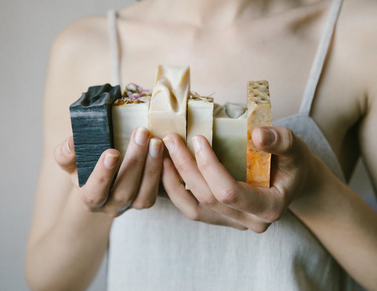 A Person Holding Soap Bars