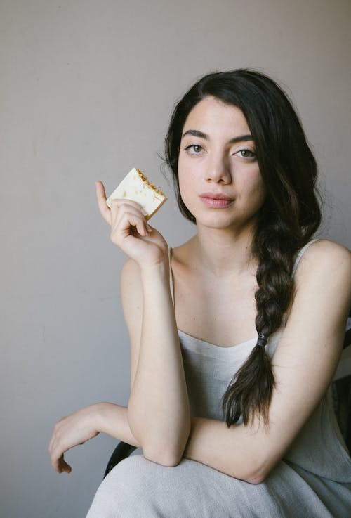 Free A Woman in a Gray Nightwear Holding a Bar of Soap Stock Photo