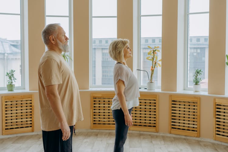 Mature Couple Standing In Studio Near Window