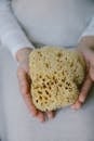 Close Up Photo of Sponge on Person's Hands