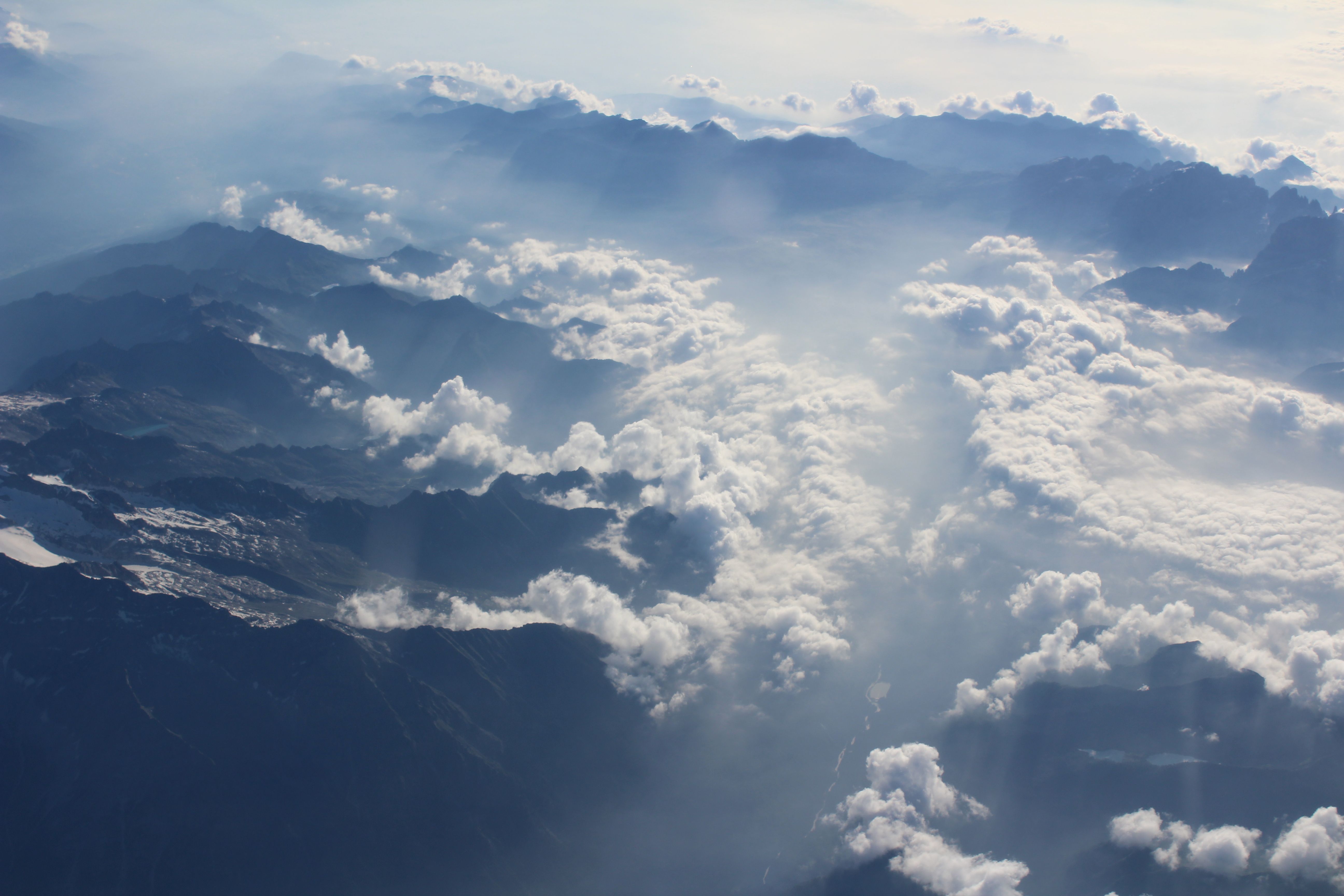 Breathtaking view of snow-capped Swiss Alps from an airplane window