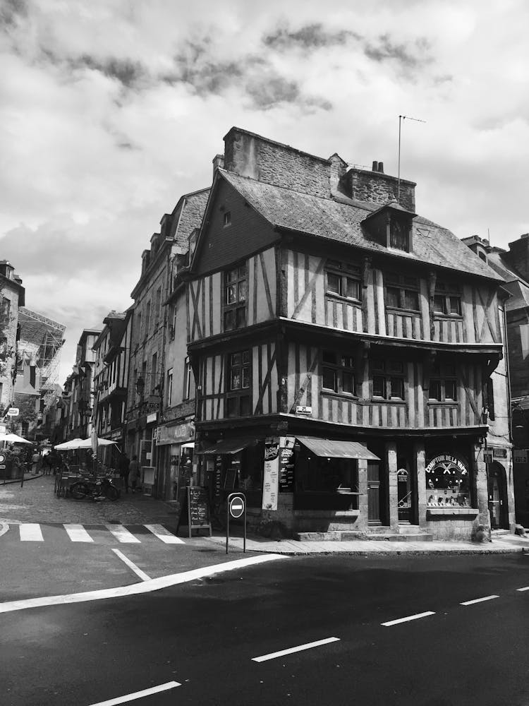 Grayscale Photo Of A Street With Commercial Buildings